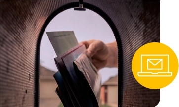 a hand pulls out mail as seen from inside a mailbox