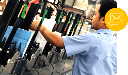a worker sorts direct mail printed pieces on the J O factory floor