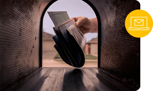 a hand pulls out mail as seen from inside a mailbox