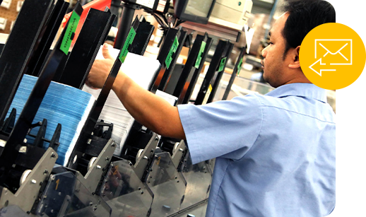 a worker sorts direct mail printed pieces on the J O factory floor