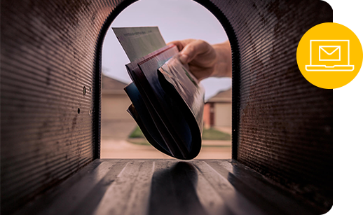 a hand pulls out mail as seen from inside a mailbox